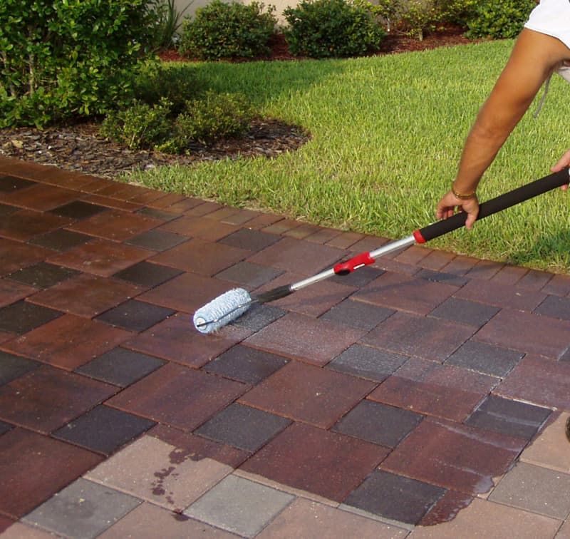 Photo of a man cleaning the pavement