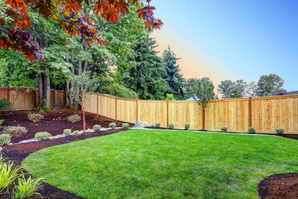 Wooden fence on a sloped backyard