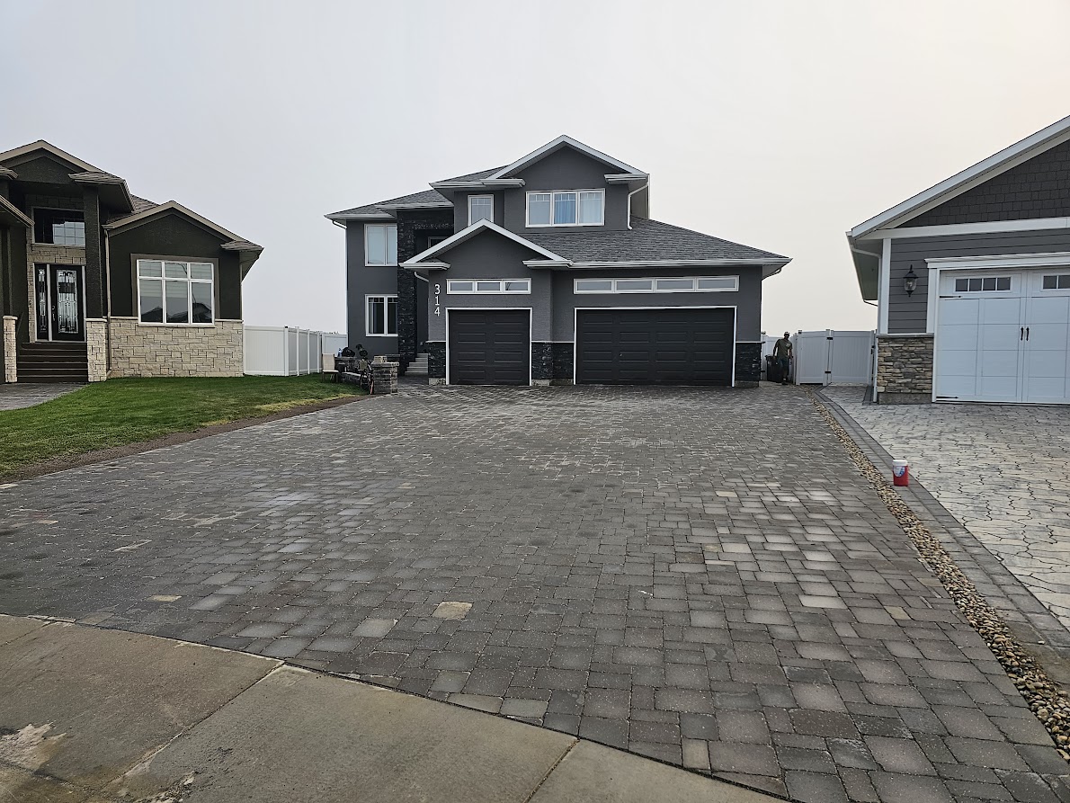 Paving stone driveway installation Saskatoon Evergreen project